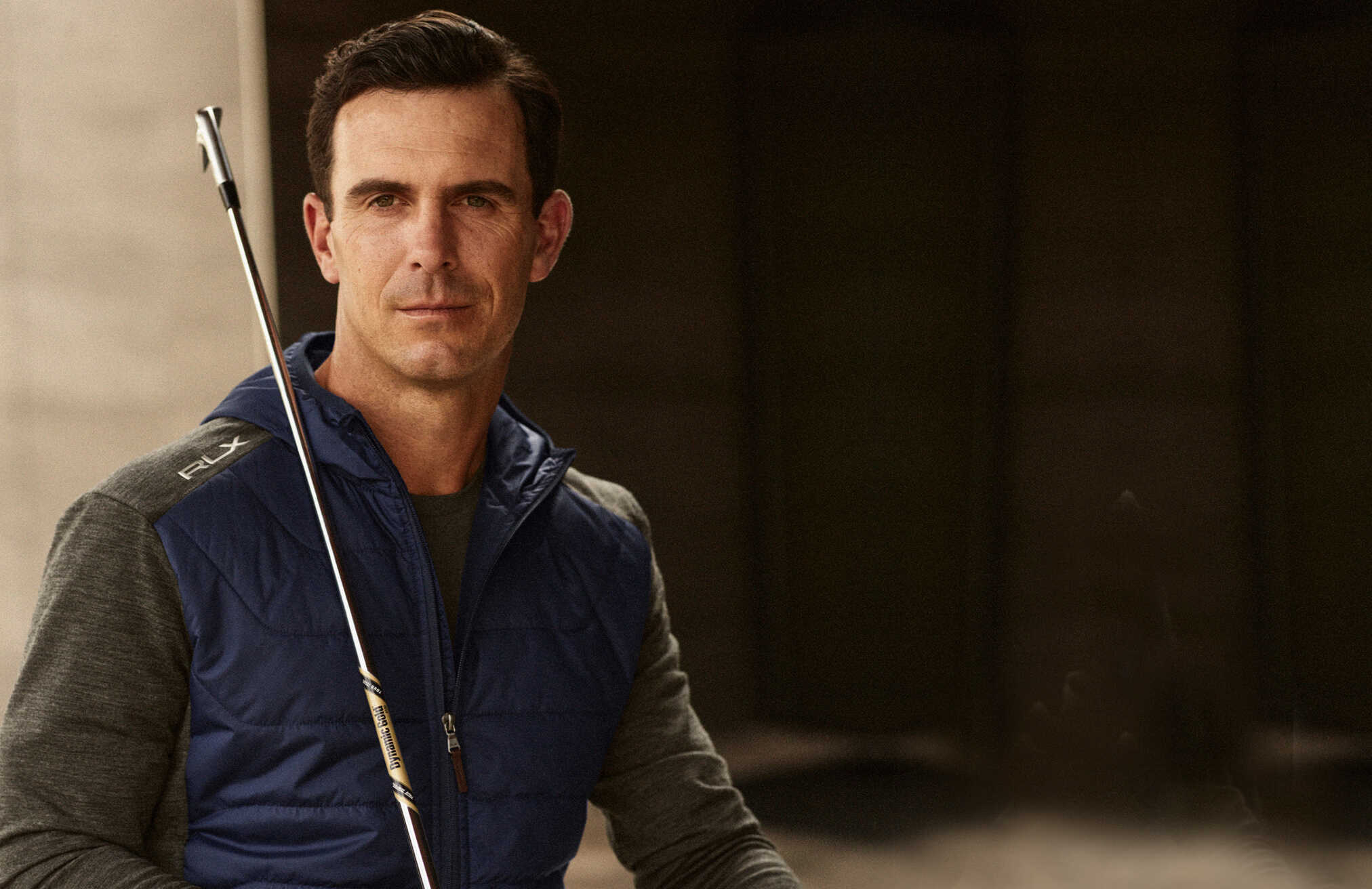 Billy Horschel wears navy and grey zip-up jacket.