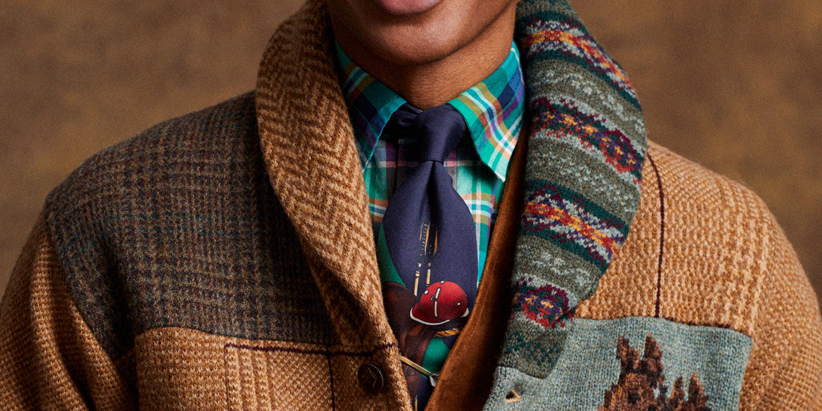 Man in patchwork tweed cardigan wears multicolored tie and plaid dress shirt.