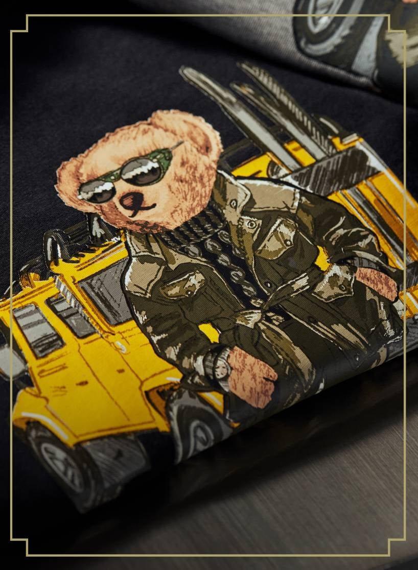 Print of Polo Bear in green jacket and sunglasses in front of yellow Jeep on black sweatshirt.