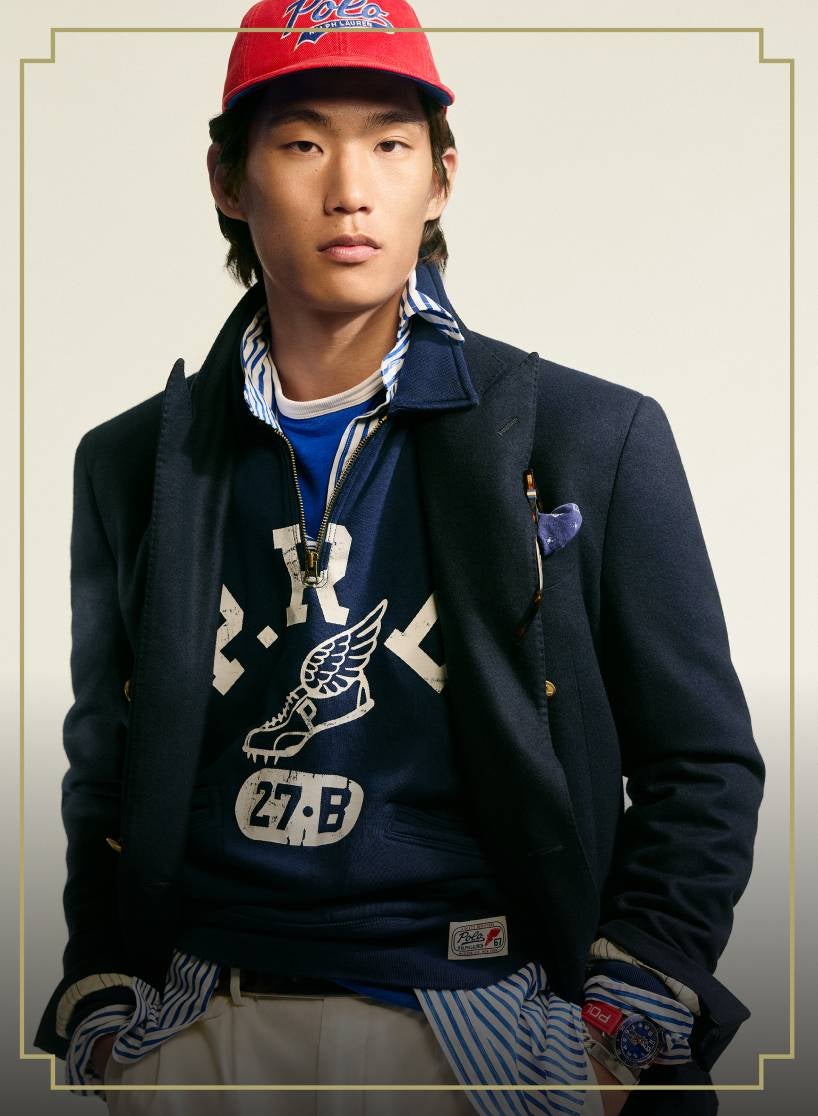 Model wearing blue jacket and white pants.